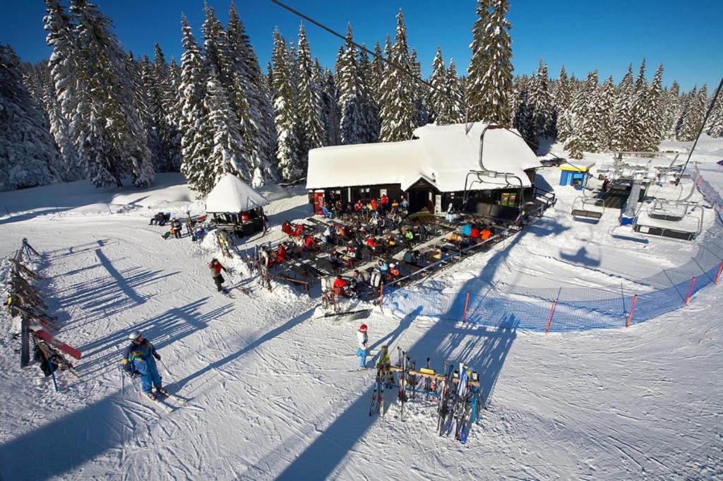 a group of people on a ski lift in the snow at Rogla - Chalet Mojca Pokrajculja in Zreče