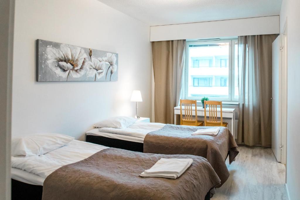 Uma cama ou camas num quarto em Apartamentos Joensuu - Kauppakatu 7