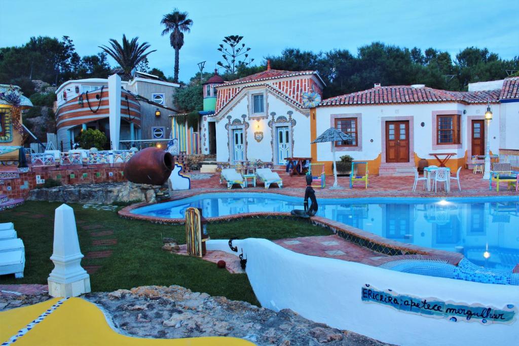 a house with a boat in the yard at Villa Ana Margarida Beach in Ericeira