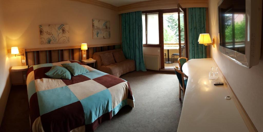 Postel nebo postele na pokoji v ubytování Hotel Les Remparts