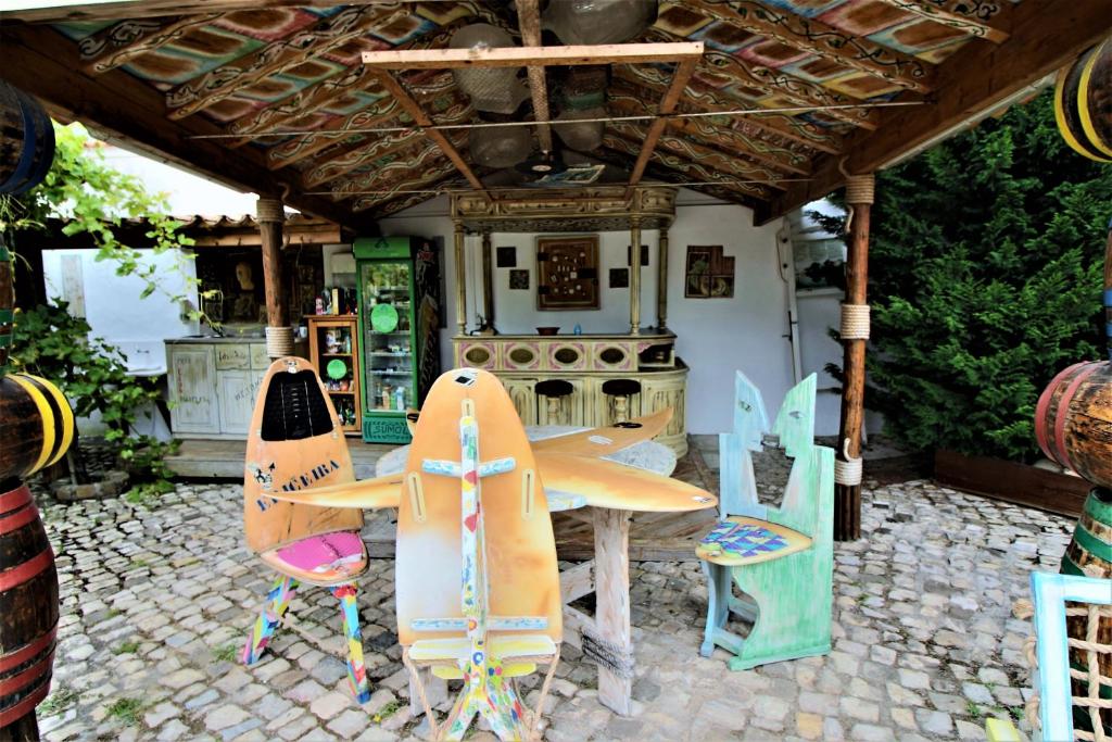 a patio with a table and chairs in front of a kitchen at Villa Ana Margarida by Nature in Ericeira