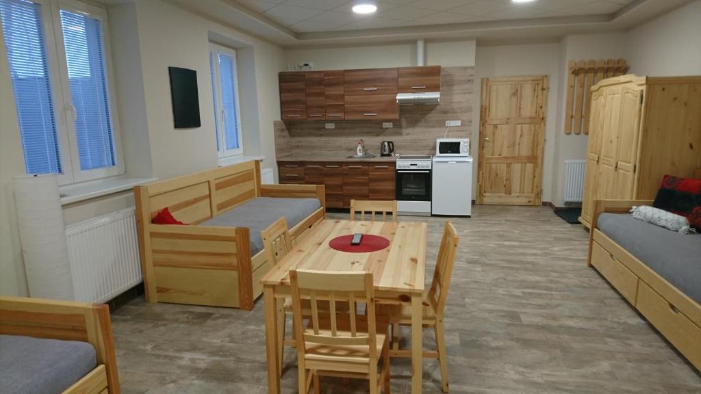 a living room with a table and a kitchen at Apartmán Žamberk in Žamberk