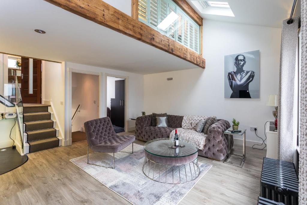 a living room with a couch and a table at The Penthouse Sale in Sale