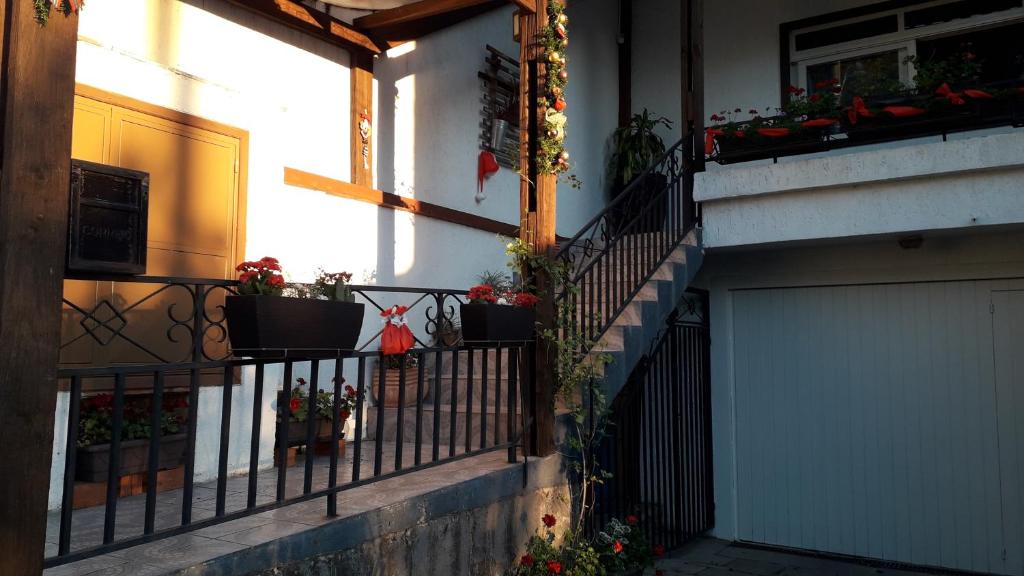 a balcony with potted plants on a house at Centro de Gramado in Gramado