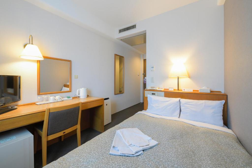 Postel nebo postele na pokoji v ubytování Shonandai Daiichi Hotel Fujisawa Yokohama