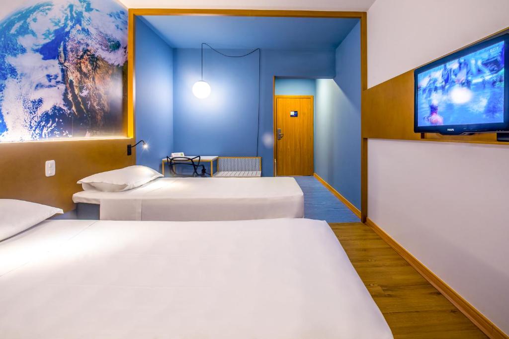 Postel nebo postele na pokoji v ubytování Hotel Euro Suite Curitiba Batel By Nacional Inn