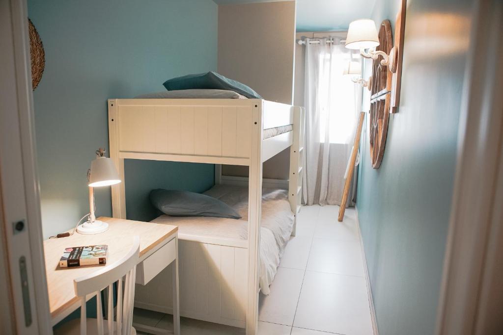 a small room with a bunk bed and a desk at Terradamare in Monopoli