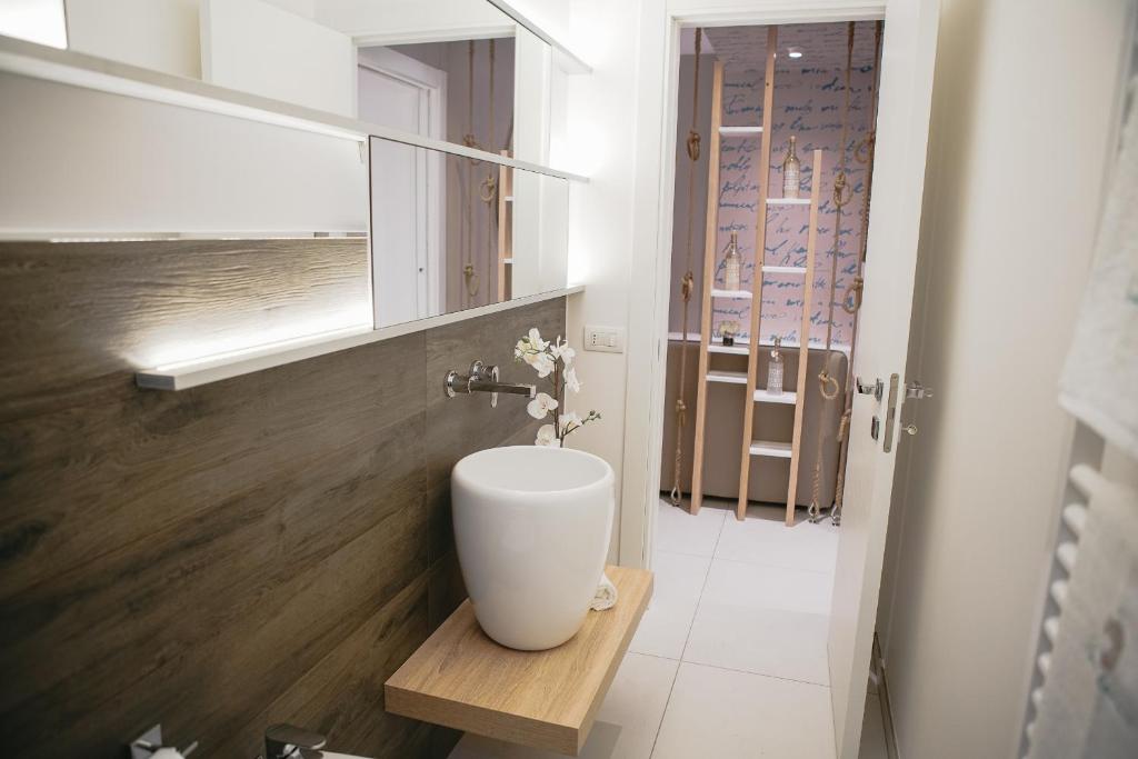 a bathroom with a vase sitting on a wooden table at Terradamare in Monopoli