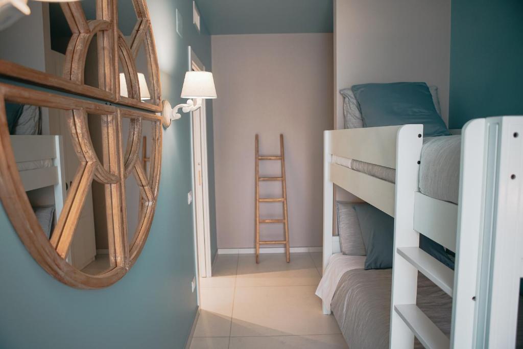 a bedroom with bunk beds and a mirror at Terradamare in Monopoli