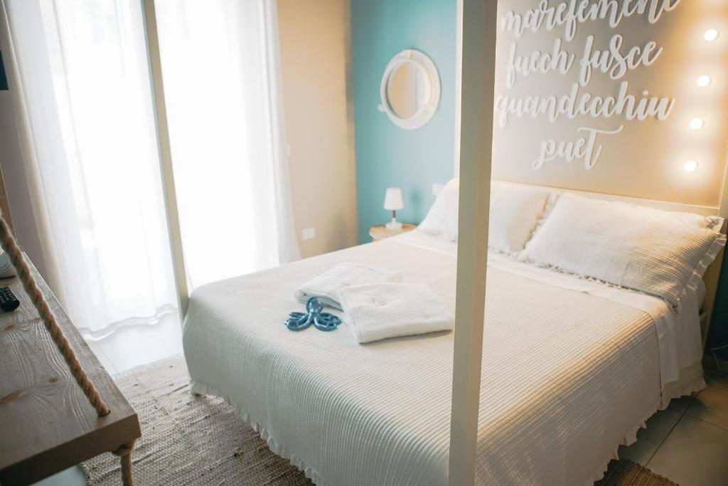 a bedroom with a bed with a sign on it at Terradamare in Monopoli