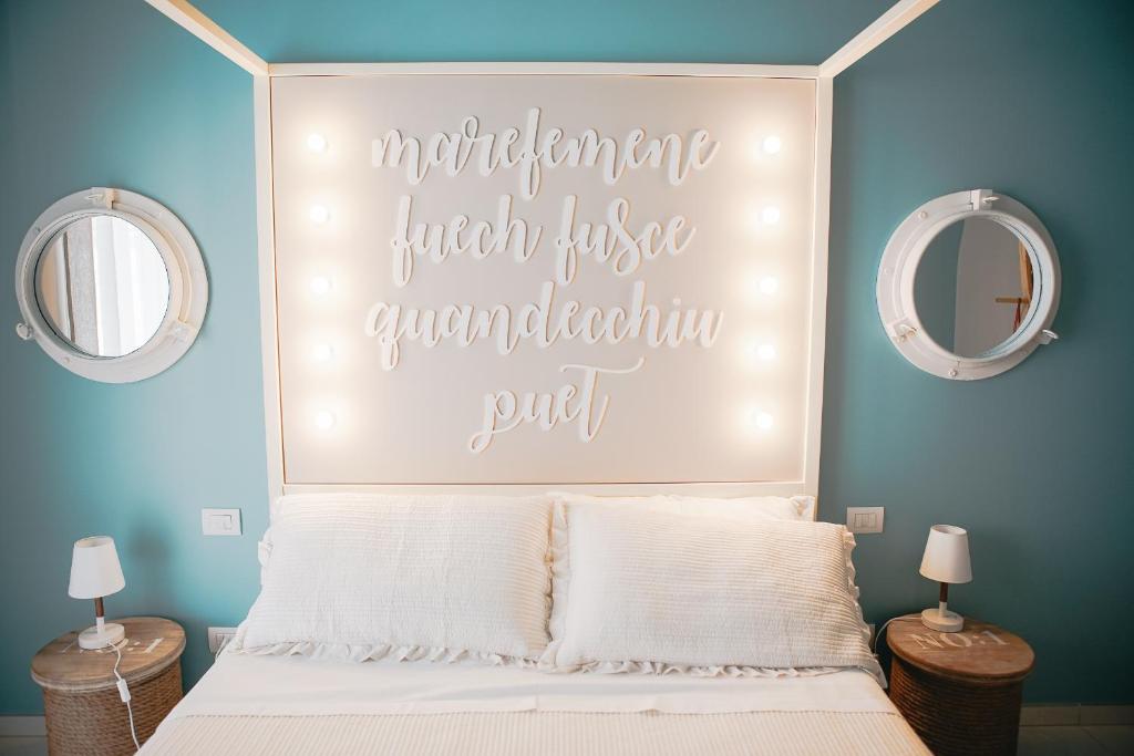a bedroom with a bed with a large headboard at Terradamare in Monopoli