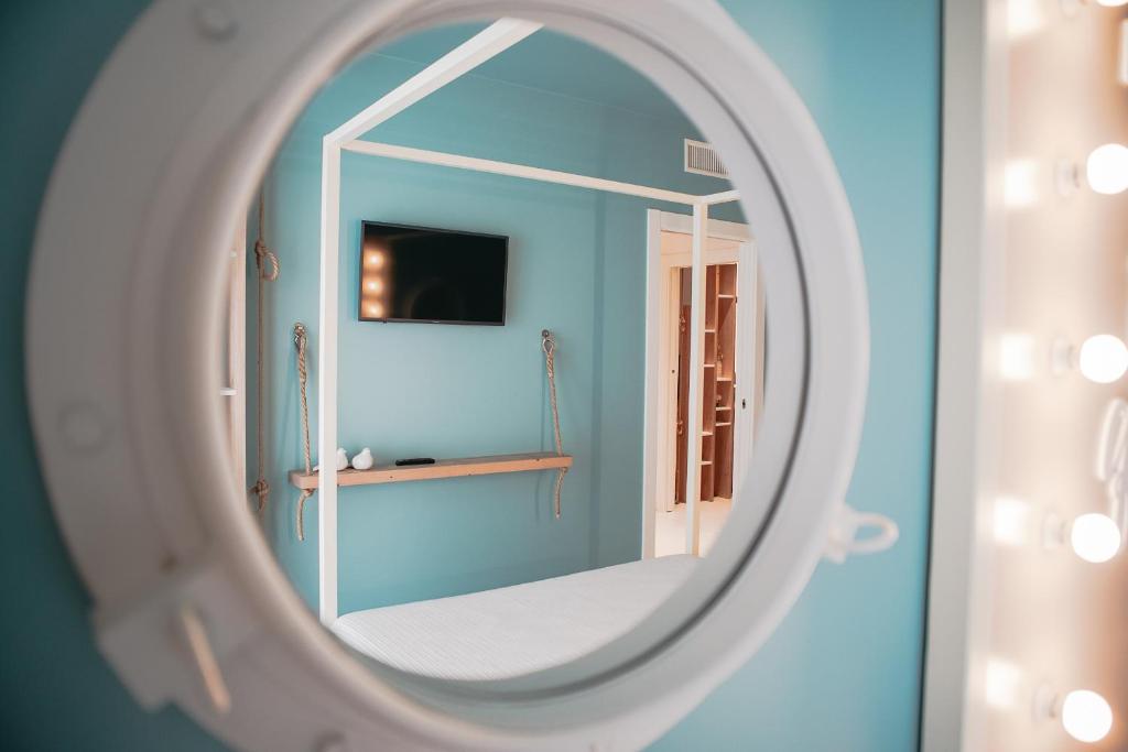 a mirror in a bathroom with a blue wall at Terradamare in Monopoli
