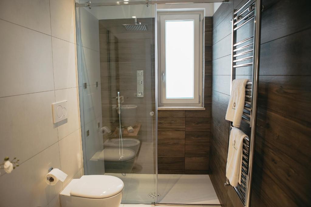 a bathroom with a toilet and a glass shower at Terradamare in Monopoli