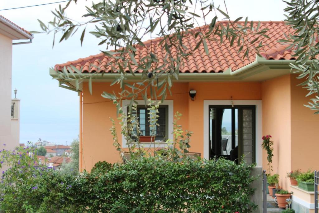 a small orange house with a red roof at View House in Agria