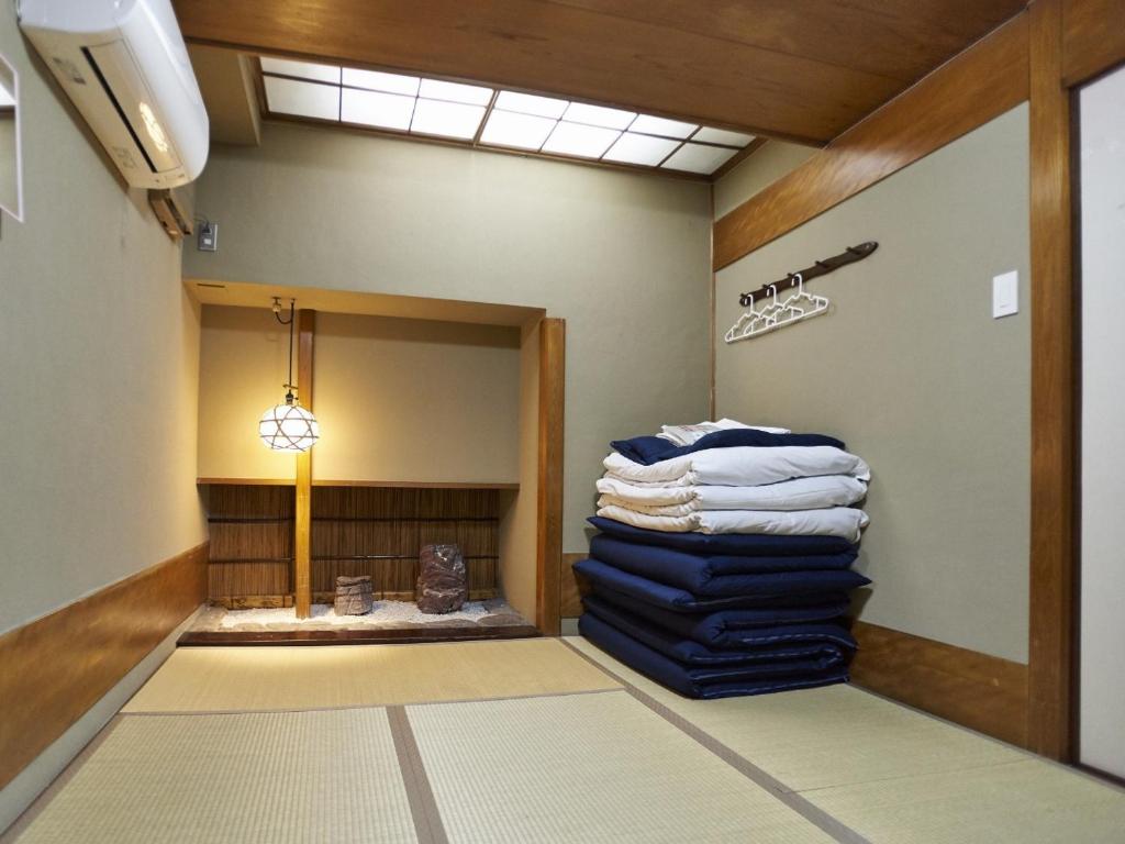 a room with a pile of towels on a wall at Osaka guest house sakura / Vacation STAY 2409 in Osaka