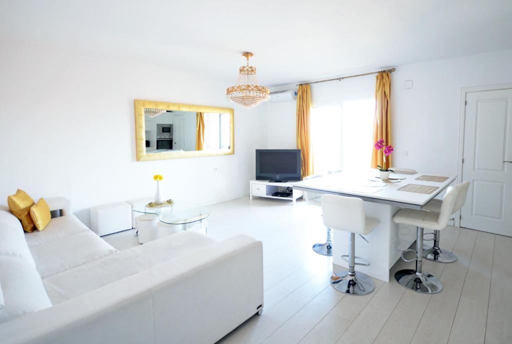 a white living room with a white couch and a desk at Modern Apartment in Valencia in Valencia