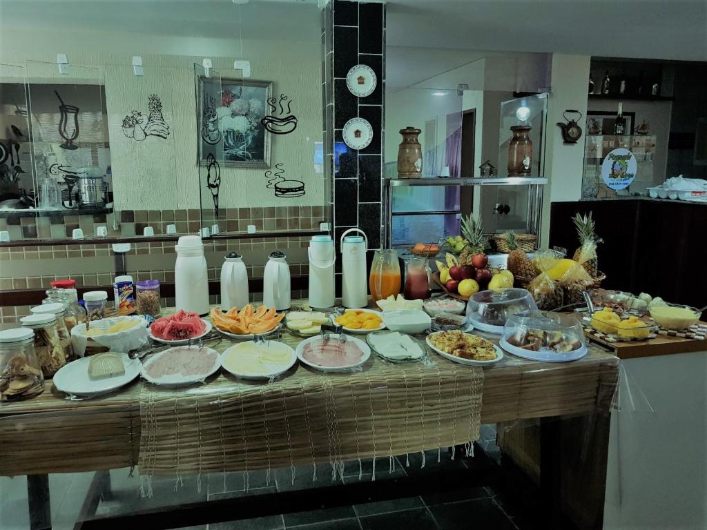 a buffet of food on a table in a kitchen at Pousada Terra Garrida in Maceió