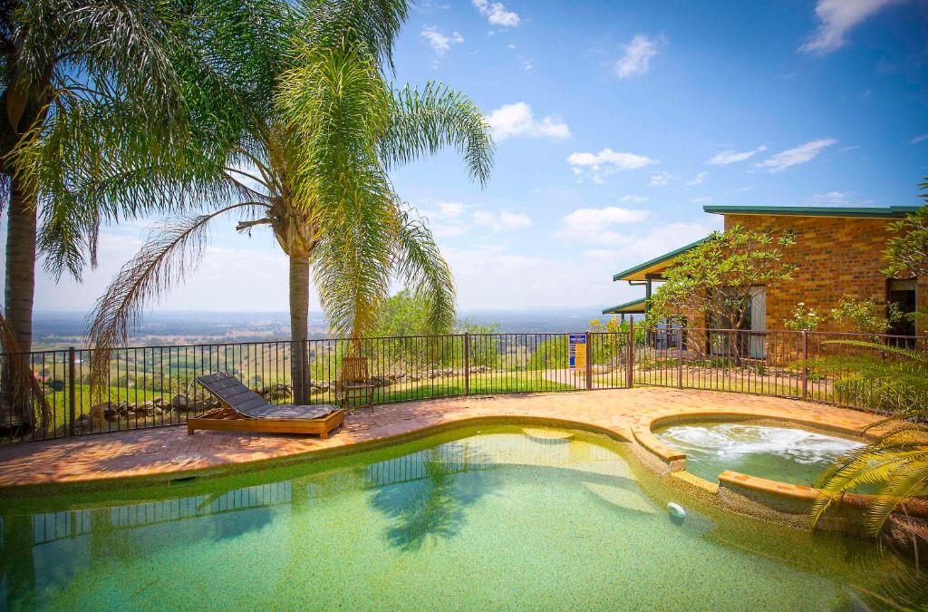 a swimming pool with a chair next to a house at Aquila in Mount View