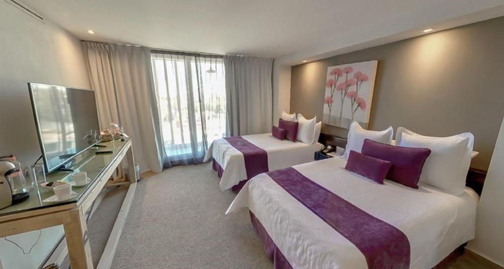Postel nebo postele na pokoji v ubytování NEhotel Nueva Estancia