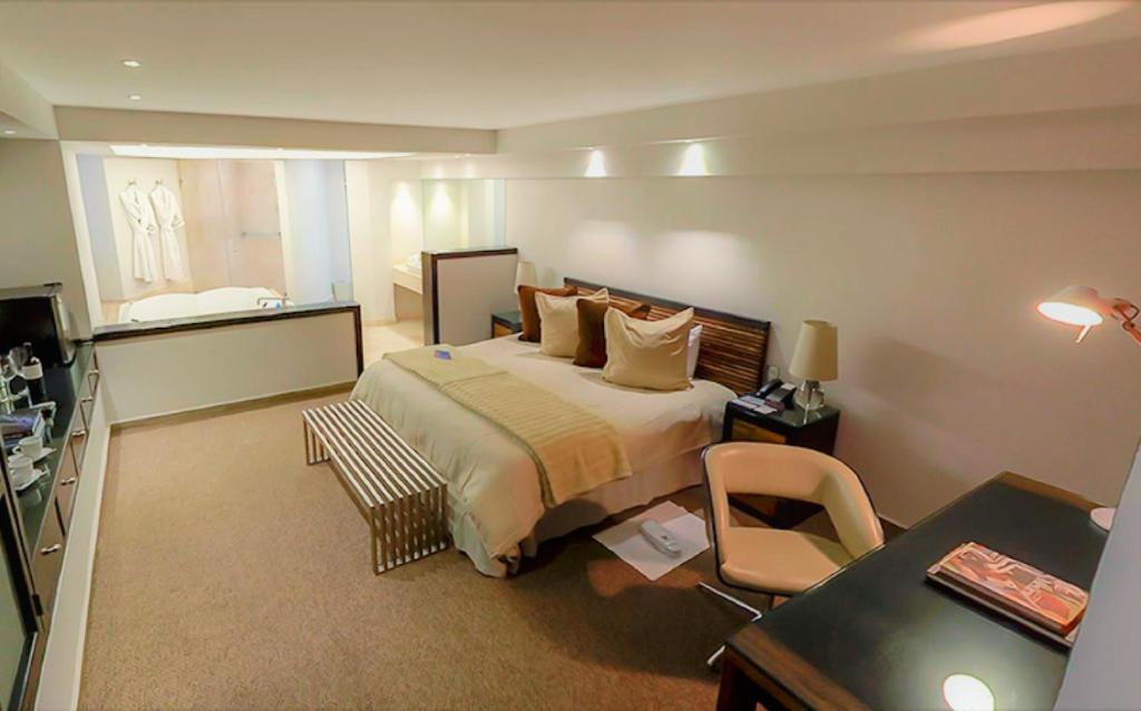 Postel nebo postele na pokoji v ubytování NEhotel Nueva Estancia
