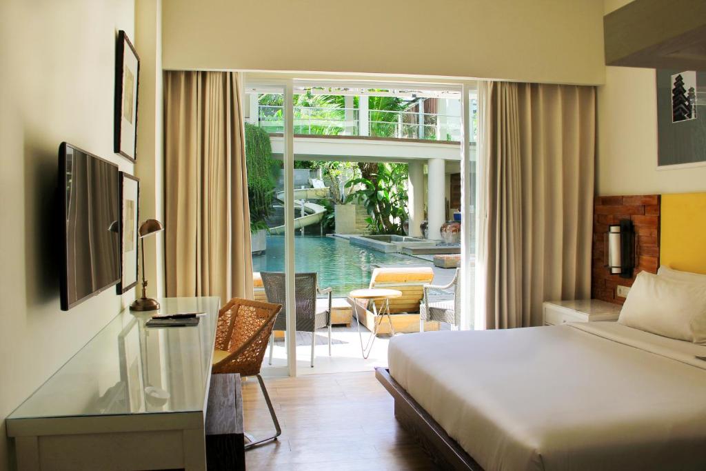 Postel nebo postele na pokoji v ubytování Bali Paragon Resort Hotel