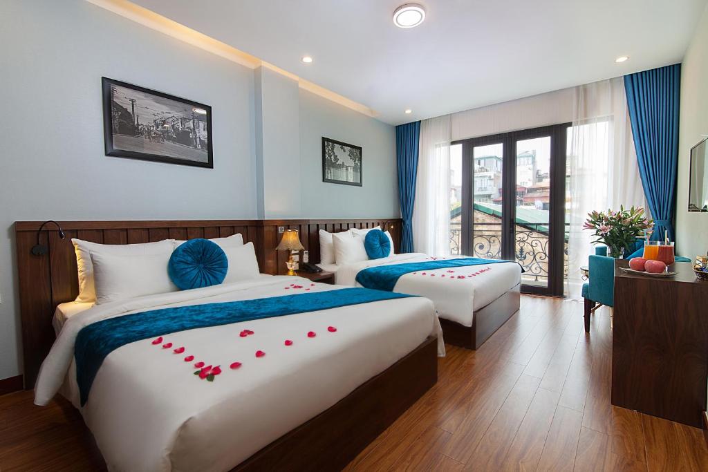 Giường trong phòng chung tại Hanoi Hanvet Hotel