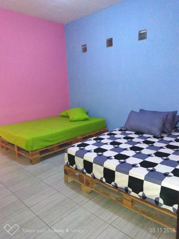 Postel nebo postele na pokoji v ubytování Bromo Tanjung