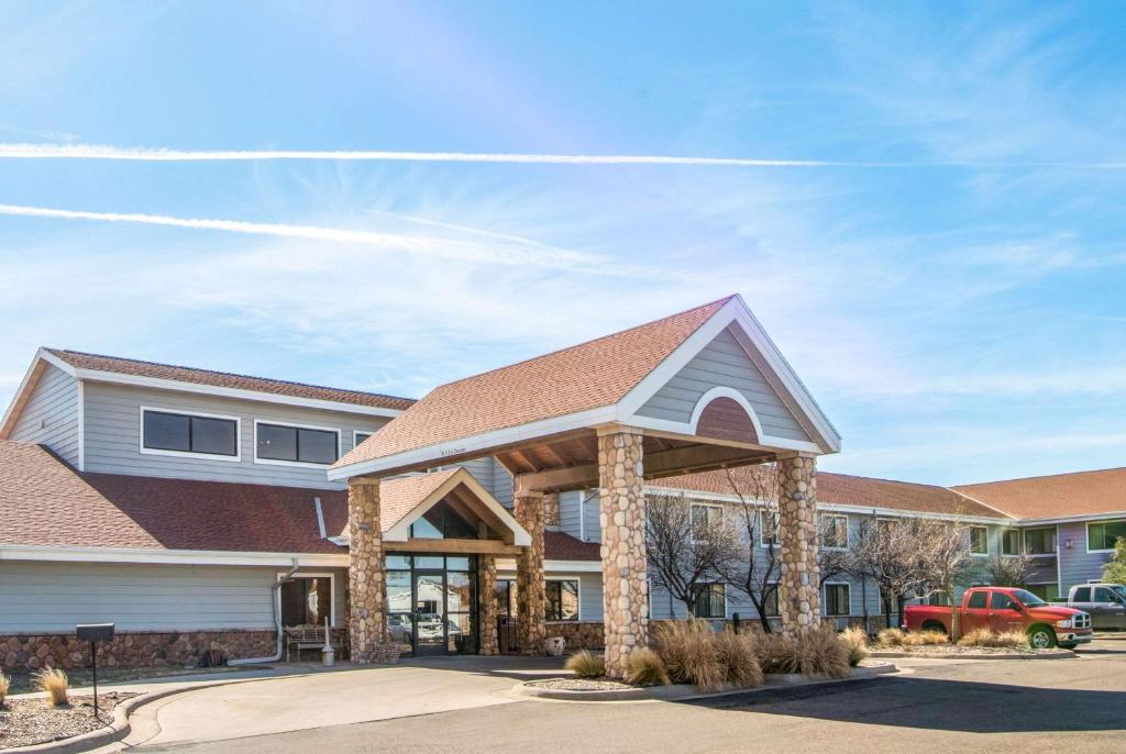 a large building with a roof at AmericInn by Wyndham Pampa Event Center in Pampa