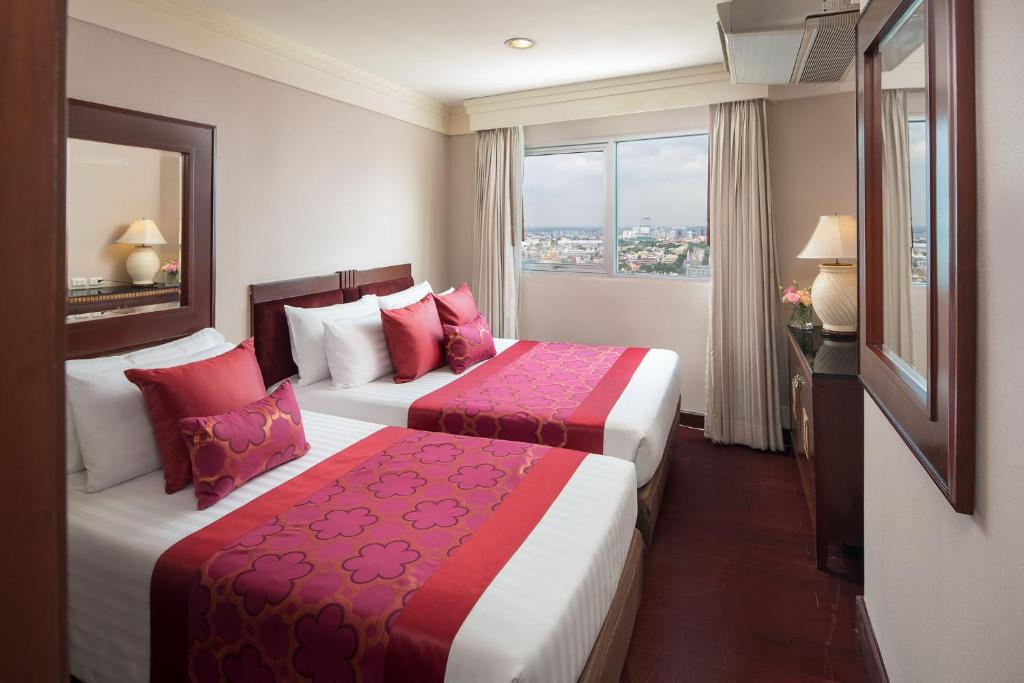 Postel nebo postele na pokoji v ubytování Prince Palace Hotel Bangkok