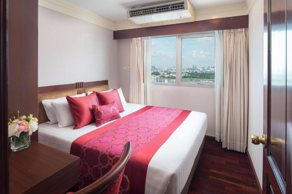 Postel nebo postele na pokoji v ubytování Prince Palace Hotel Bangkok