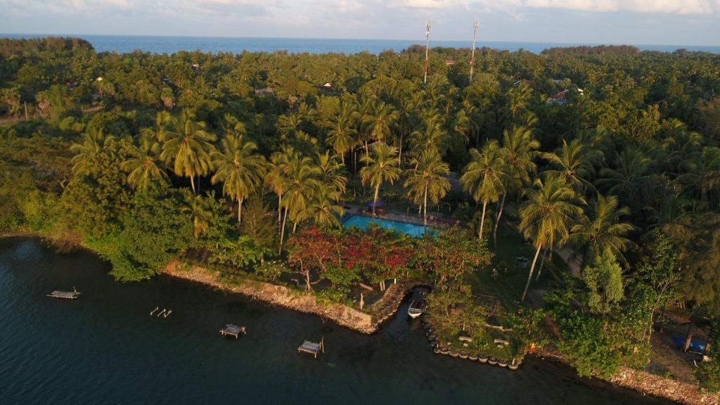 an aerial view of a resort with a pool and palm trees at Riviera Resort in Batticaloa