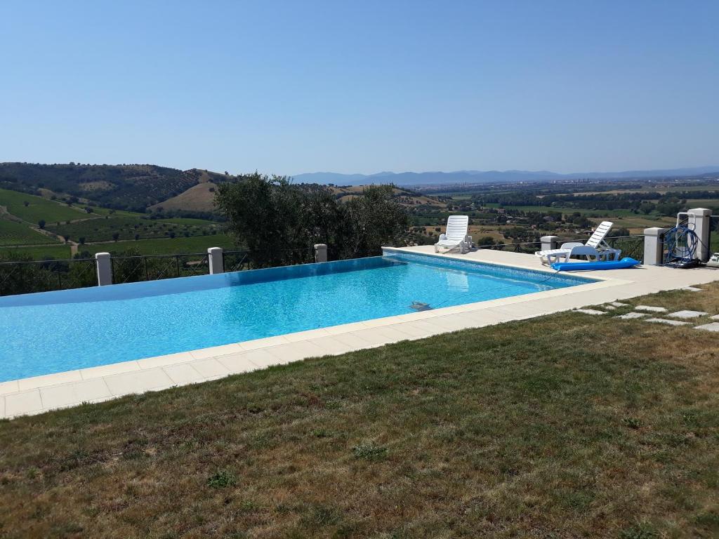 a swimming pool on the side of a house at Poggio Lungo in Grosseto