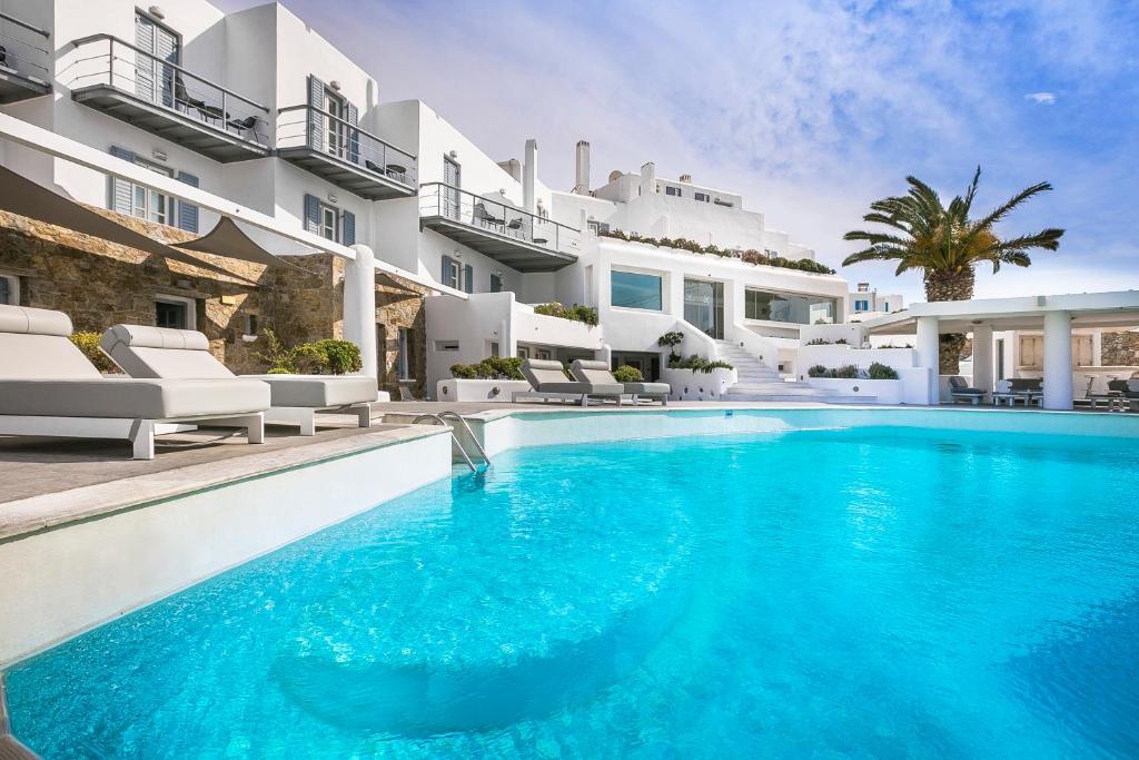a swimming pool in front of a villa at Ilio Maris in Mýkonos City