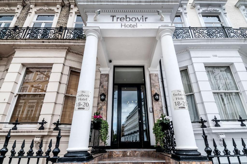 a large white building with a large window at Trebovir Hotel in London