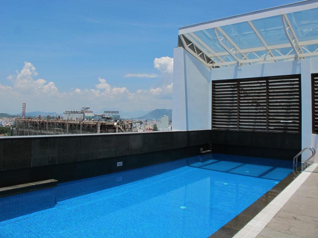 a swimming pool on the roof of a building at Nhi Phi Hotel in Nha Trang