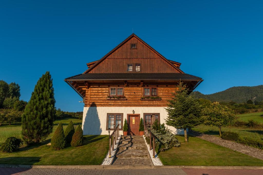 a large wooden house with a brown roof at Koliba Likava in Likavka