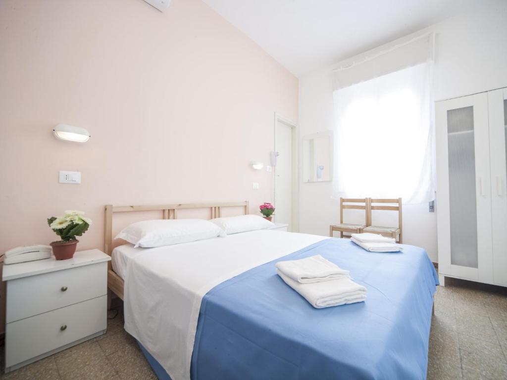 Posteľ alebo postele v izbe v ubytovaní Hotel Colombo