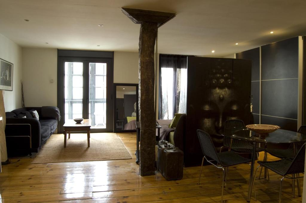 a living room with a table and a couch at Apartamentos Ondoloin in Vitoria-Gasteiz
