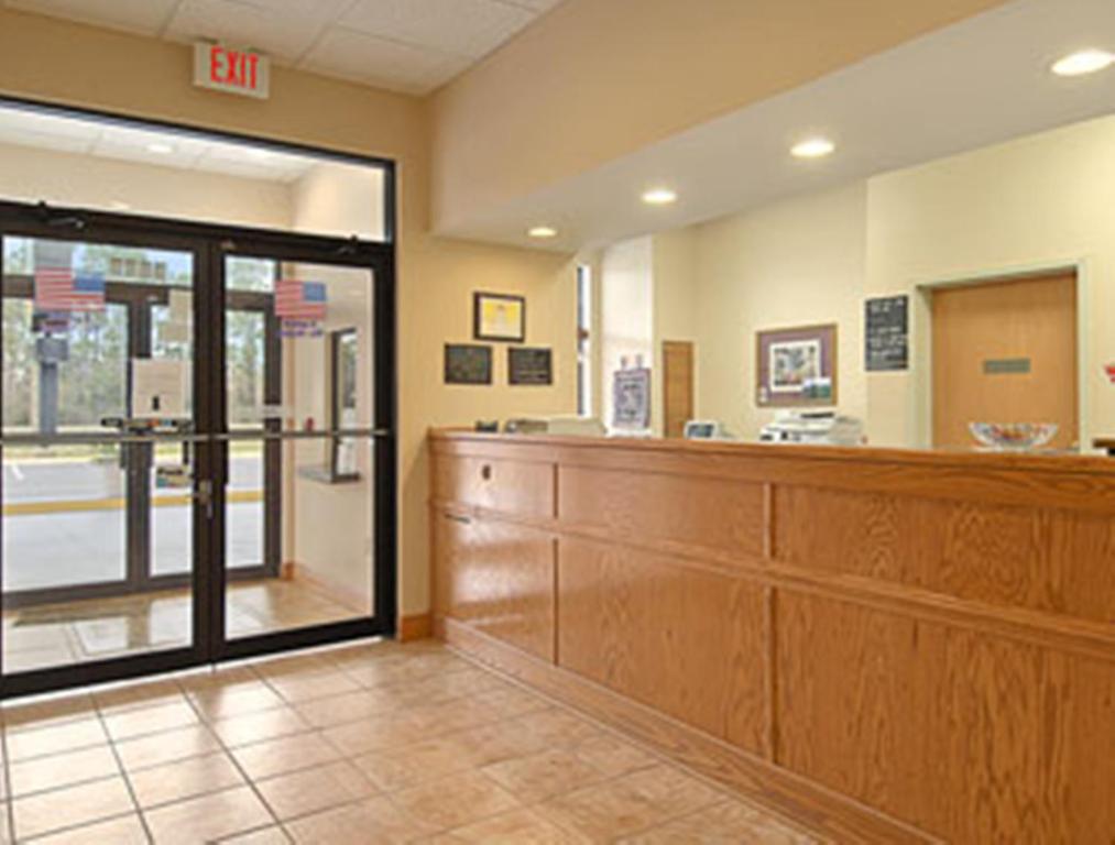 a waiting area of a hospital with a wooden practition at Super 8 Pascagoula in Pascagoula