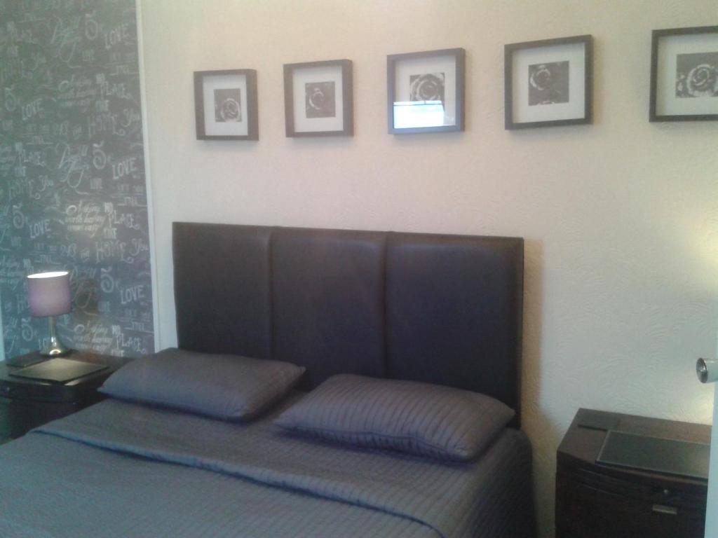 a bedroom with a bed and pictures on the wall at Avenue Road in Gateshead