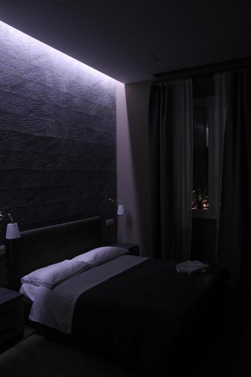 Łóżko lub łóżka w pokoju w obiekcie City Break Nomentana