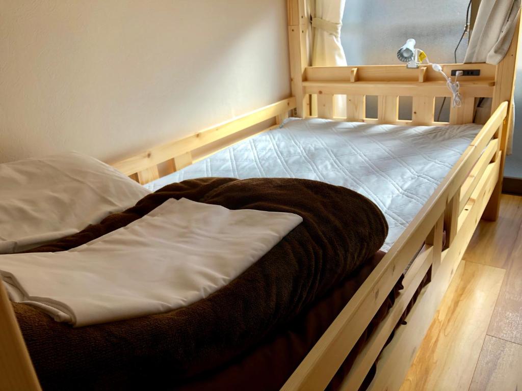 Postel nebo postele na pokoji v ubytování HISAYO'S INN