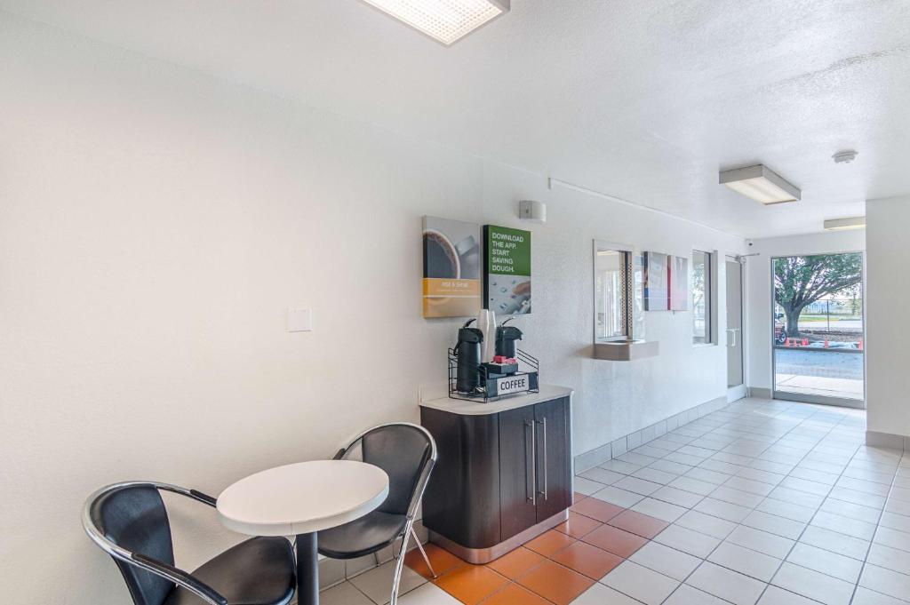 a room with a table and chairs and a table at Motel 6-Ardmore, OK in Ardmore