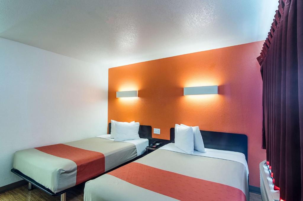 a hotel room with two beds with colorful walls at Motel 6-Ardmore, OK in Ardmore