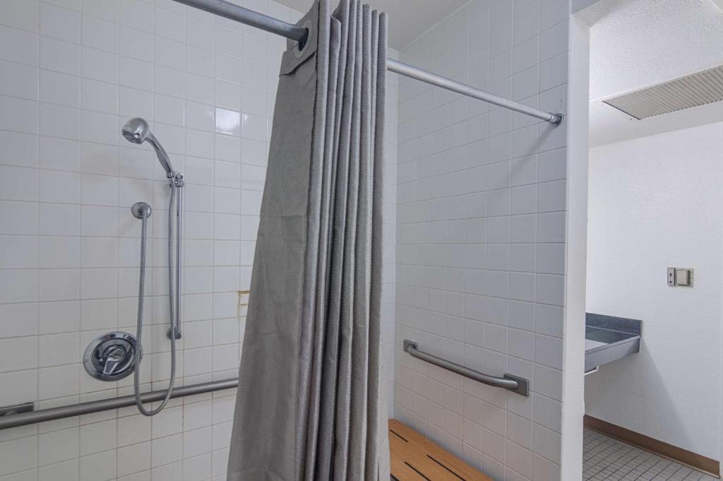 a shower with a shower curtain in a bathroom at Motel 6-Ardmore, OK in Ardmore