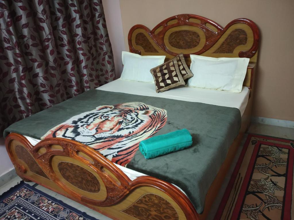 a bedroom with two twin beds and a green pillow at Pratibha Home stay in Jabalpur