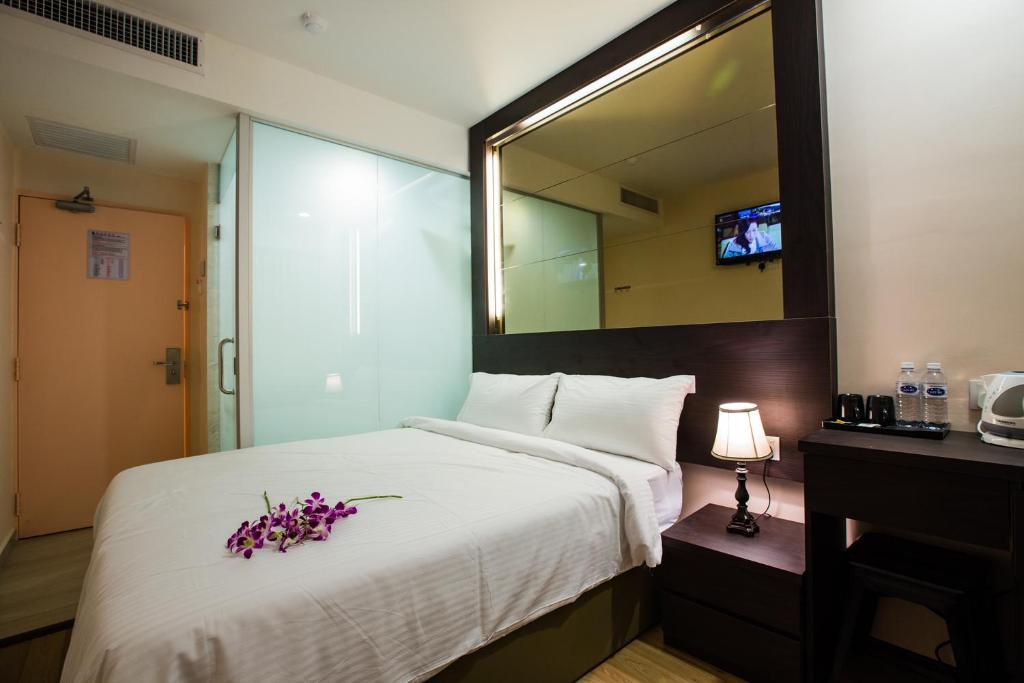 Postel nebo postele na pokoji v ubytování Hotel CIQ @ Wong Ah Fook