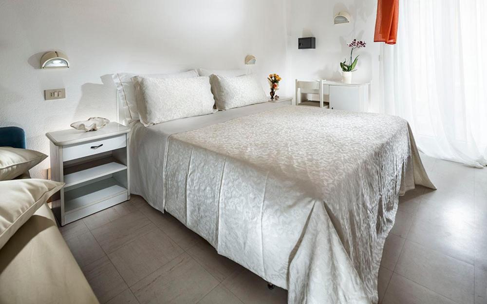 Postel nebo postele na pokoji v ubytování Hotel Capinera