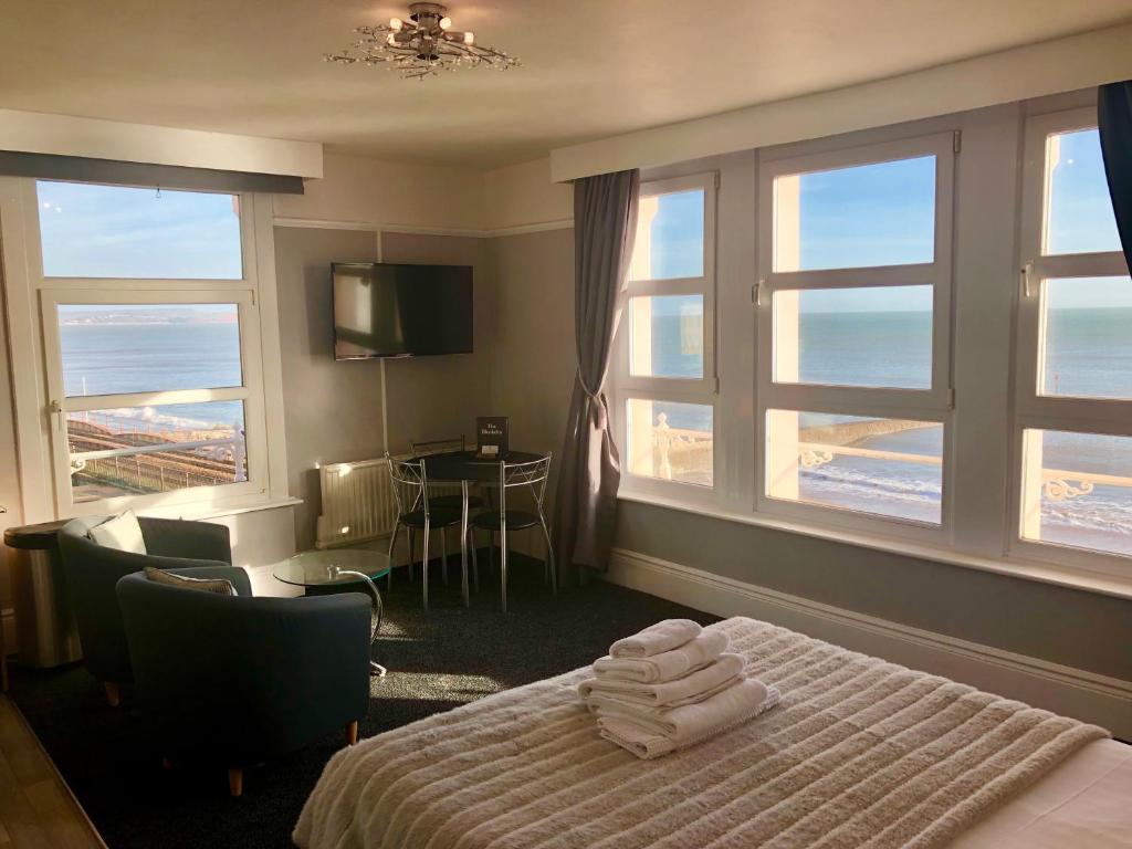 a hotel room with a bed with towels on it at The Blenheim in Dawlish