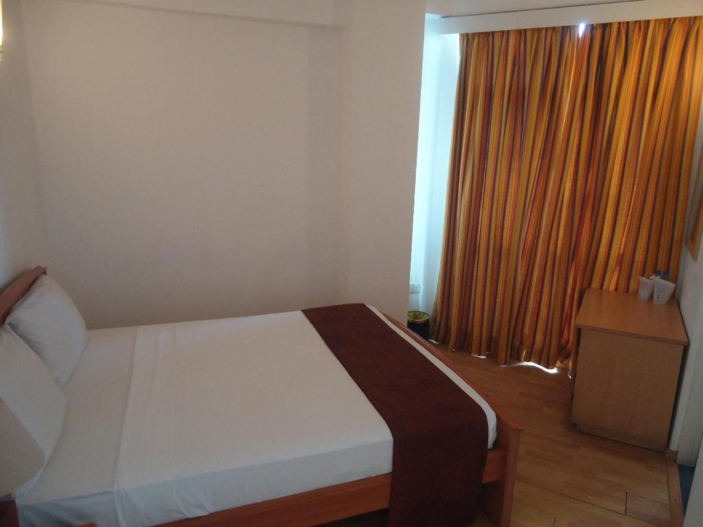 Postel nebo postele na pokoji v ubytování Global Towers Hotel & Apartments